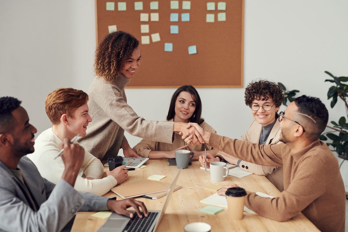Education agency partners shaking hands in an office