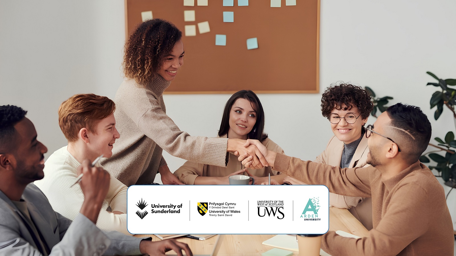 Education agency partners shaking hands in an office